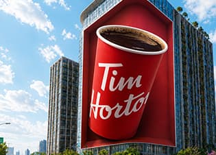 Tim Hortons coffee cup creative displayed on BIG ONE against a blue sky
