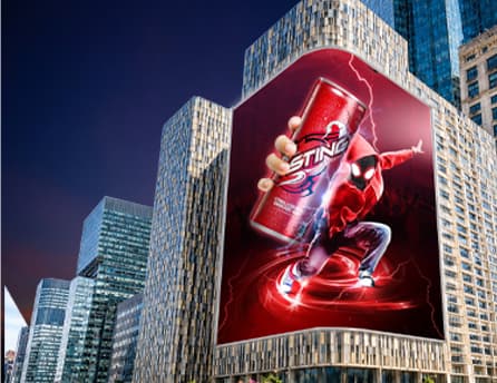 Sting energy drink creative running on BIG ONE's curved display amid city skyscrapers