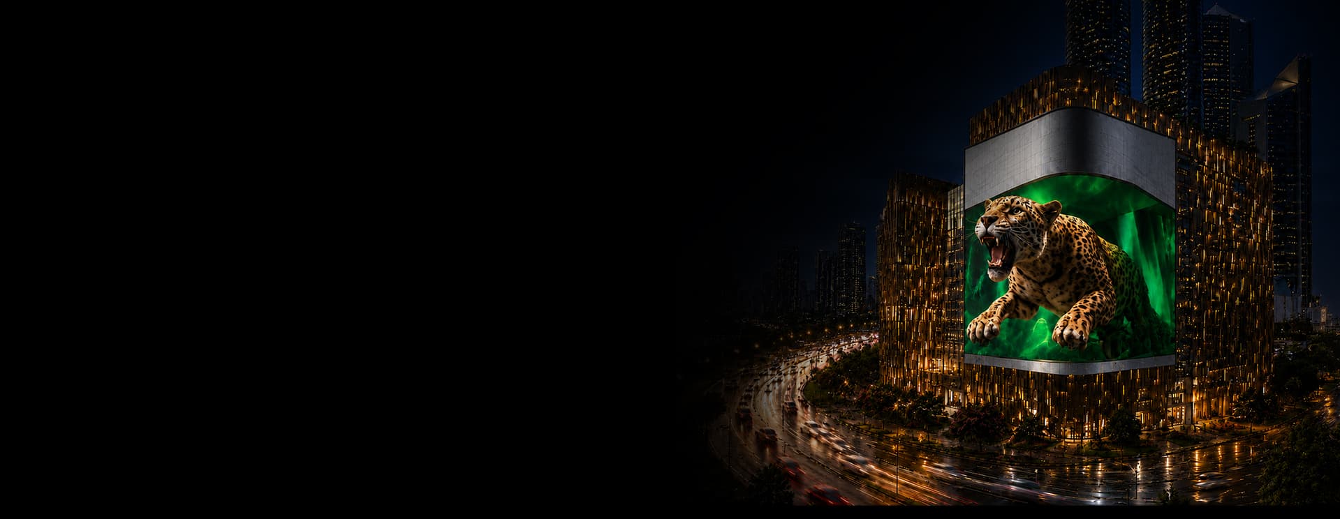 A 3D jaguar leaping out of BIG ONE's curved LED display above a Lahore street at night